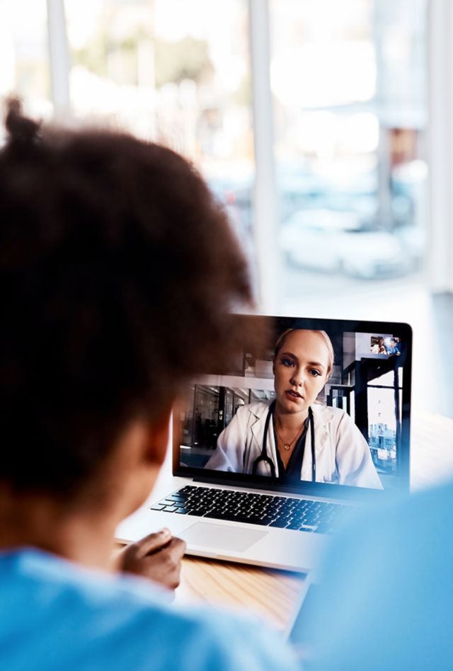 Shot of a group of young doctors having a video conference with a laptop in a hospital