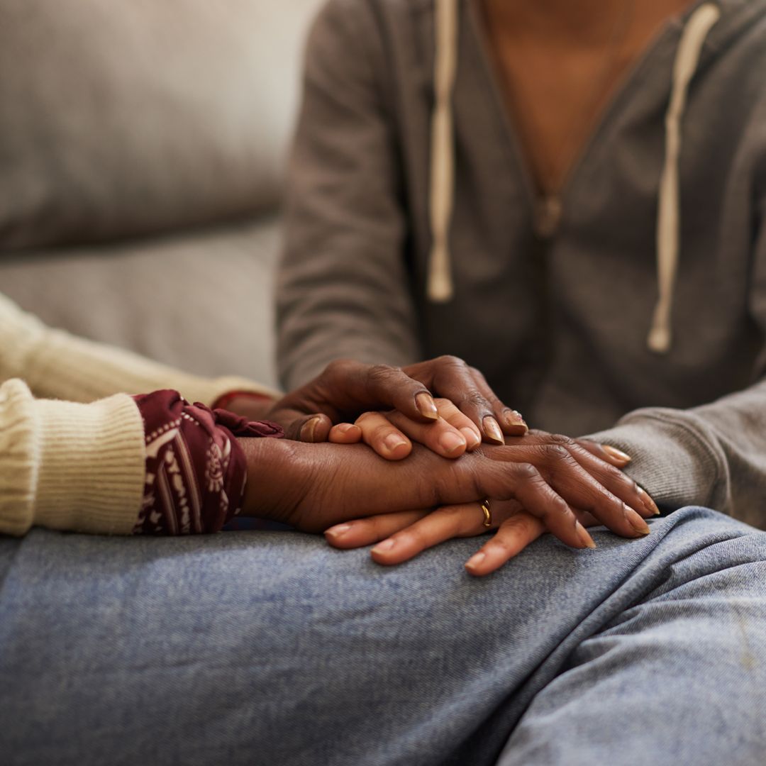 closeup image of two people hand in hand
