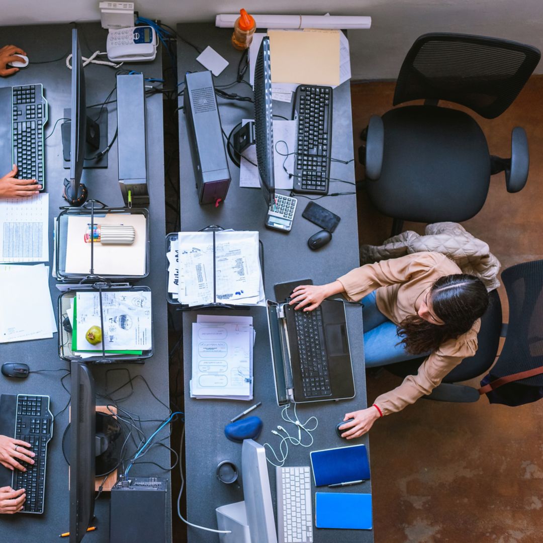 over head image of thee individuals working at computers