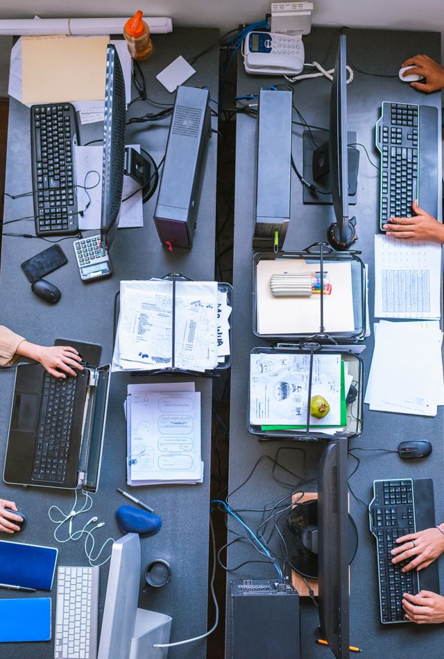 over head image of thee individuals working at computers