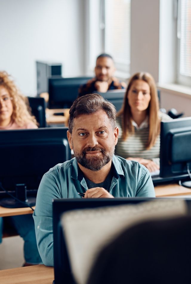 Man listening to a teacher while attending class