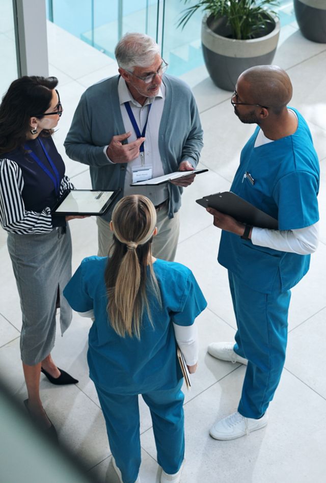 Doctors, medical team and tablet with discussion, advice and above for surgery or patient records. People, tech and nurse for professional opinion, help and results in healthcare, clinic or hospital