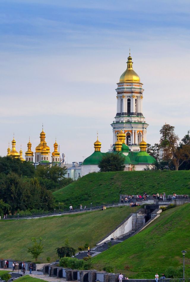 people walking near steeple, building, tower and spire in Kyiv, Ukraine