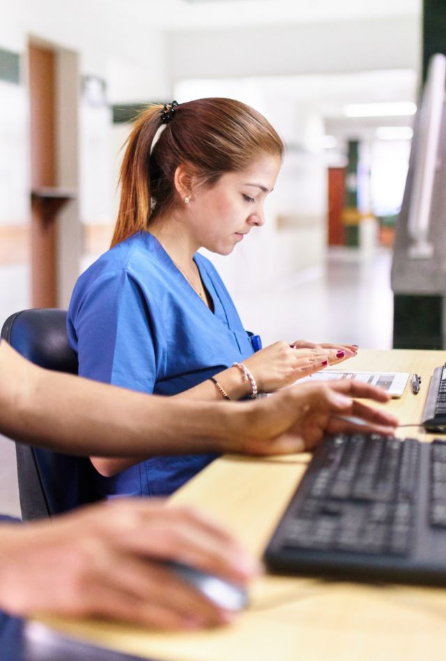 Health providers typing on laptops
