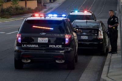 2JBYA3W La Habra, California / USA - April 27, 2022: Police units pull over a car on a city street.