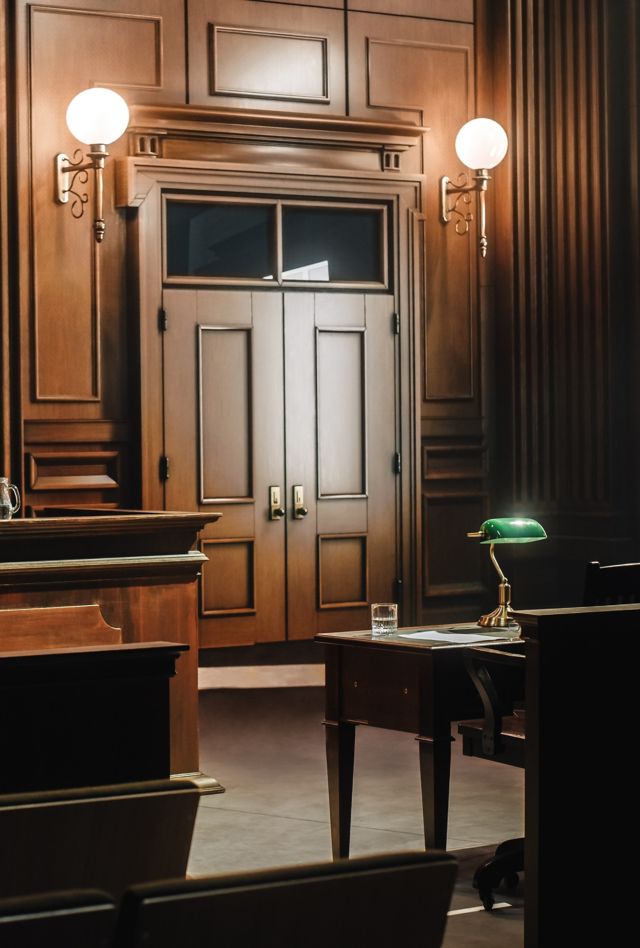 Empty American Style Courtroom. Supreme Court of Law and Justice Trial Stand. Courthouse Before Civil Case Hearing Starts. Grand Wooden Interior with Judge's Bench, Defendant's and Plaintiff's Tables.