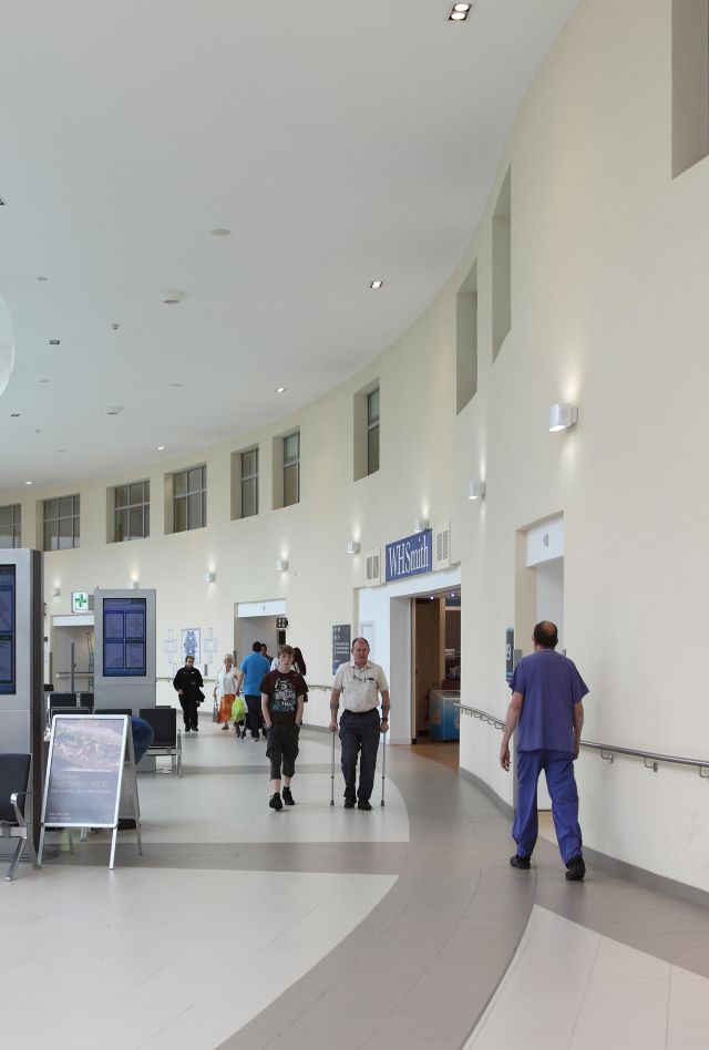 People walking through the hallway of a hospital