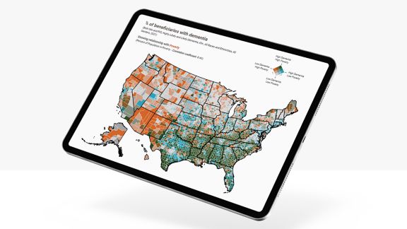 Tablet displaying a U.S. map showing county-level data on dementia and poverty, with colored regions indicating variation.