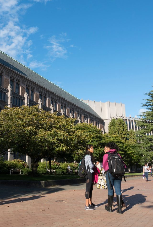 Students chatting or walking on the campus of the University of Washington, a large public university located north of downtown Seattle, Washington.