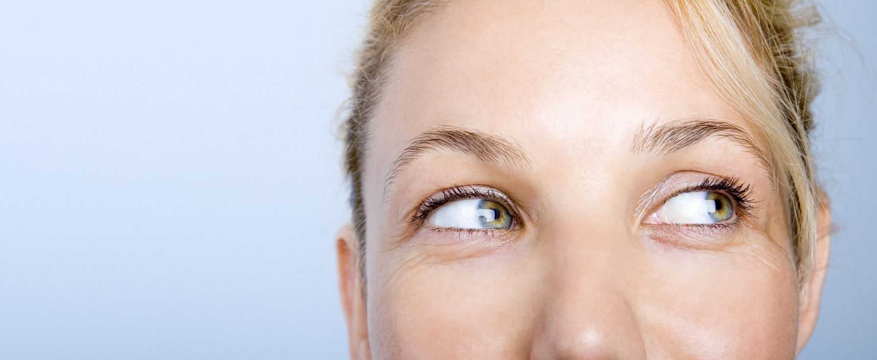 Woman with eyes peering over to the left.