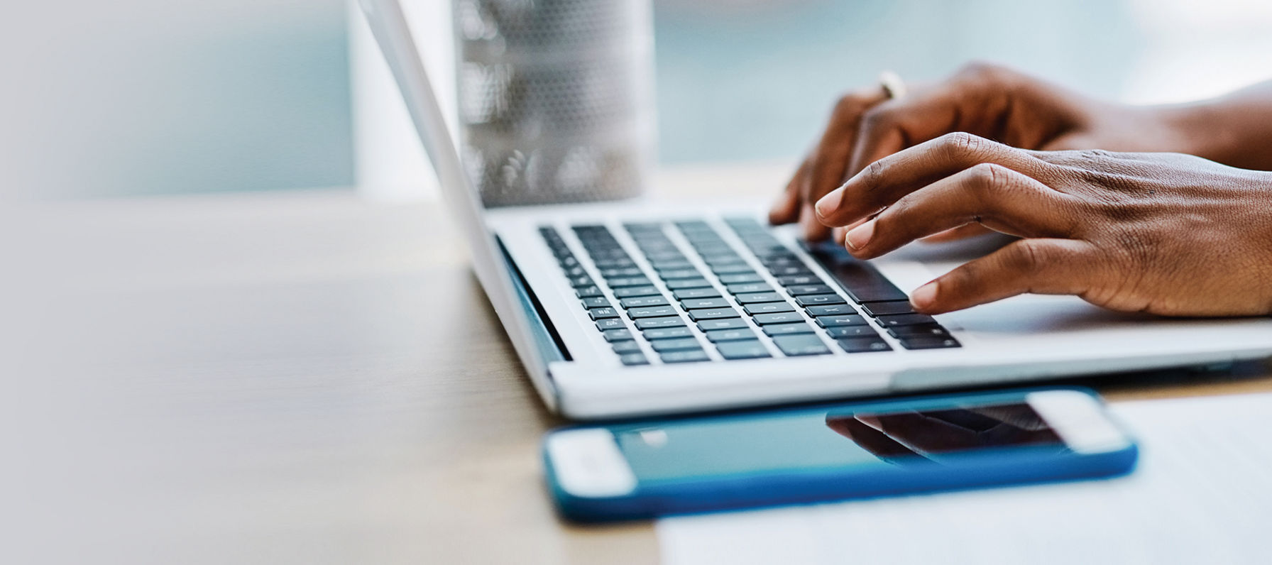 Hands on a laptop keyboard