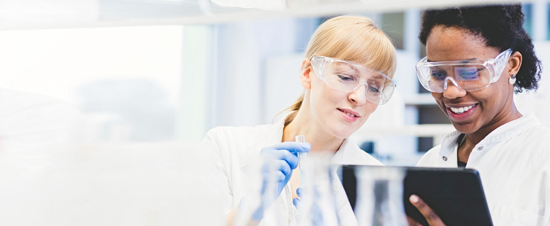 Laboratory professional working on a tablet.