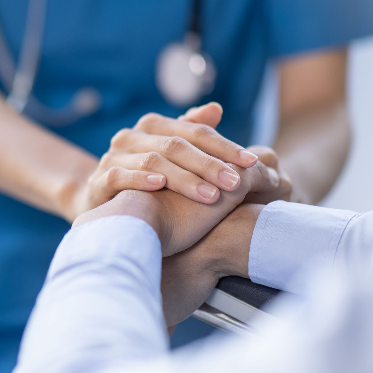 Holding hands with patient. /