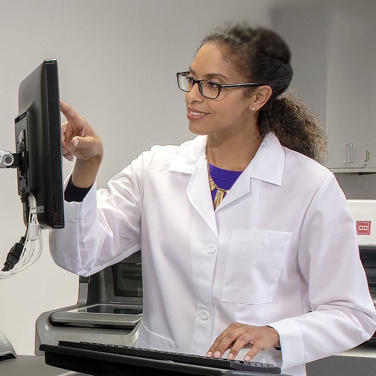 Lab professionals working with computer./