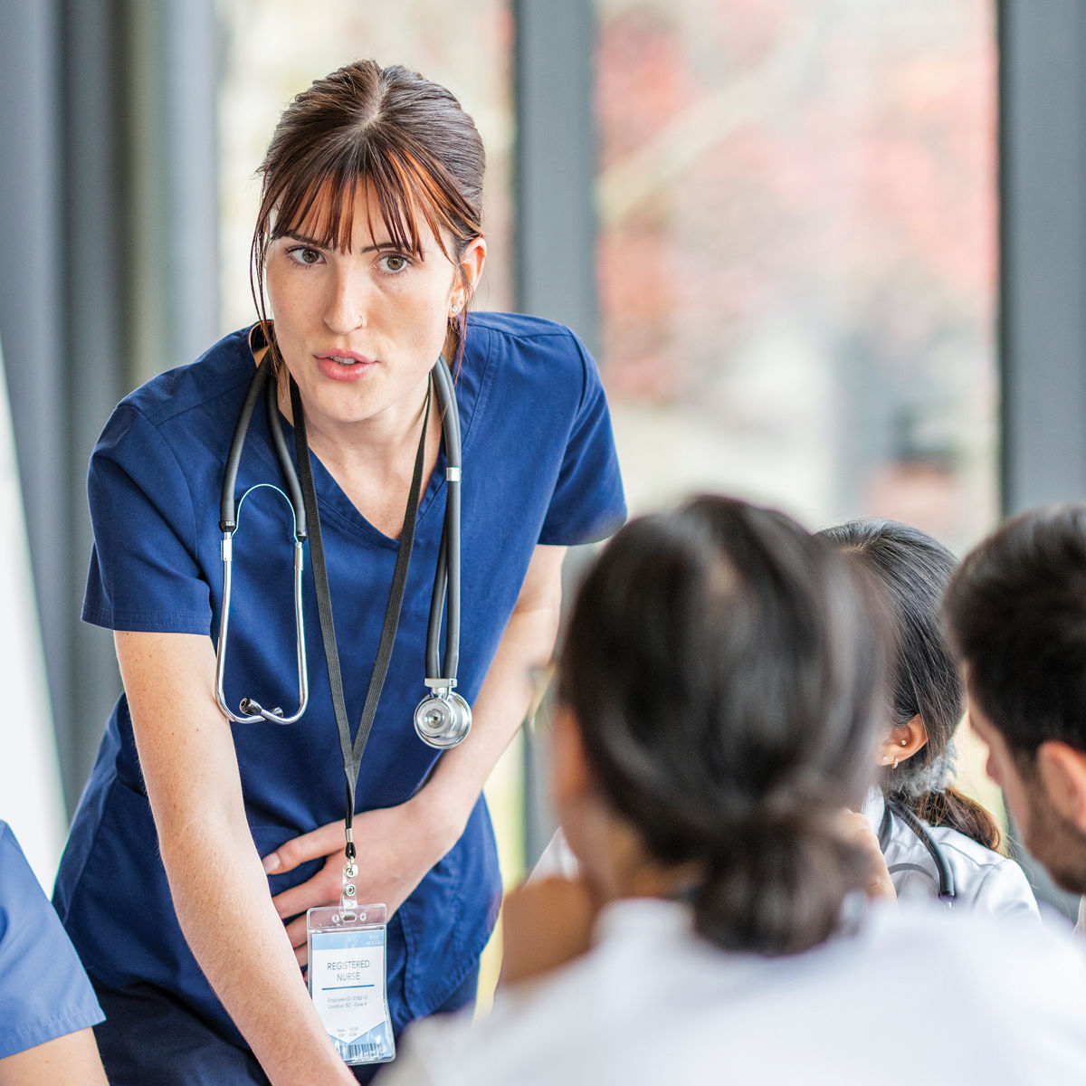 Nurse helping patients. /