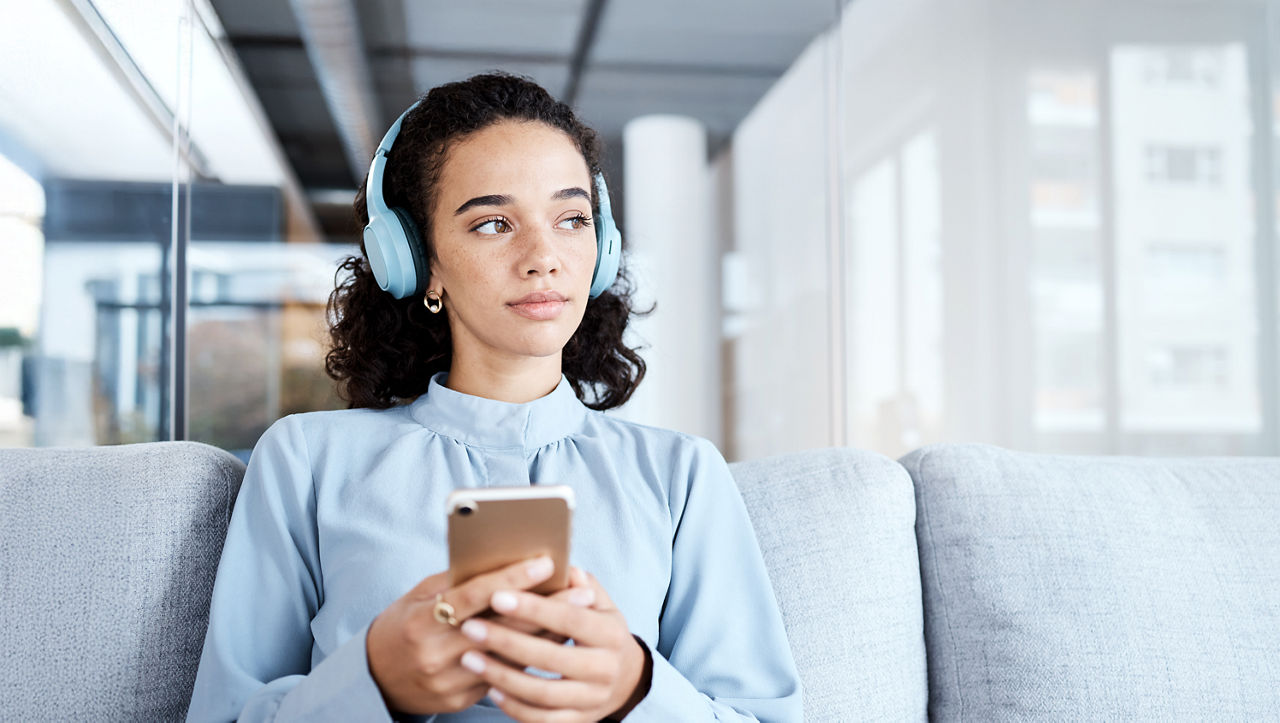 Listening to a podcast while sitting on the couch.