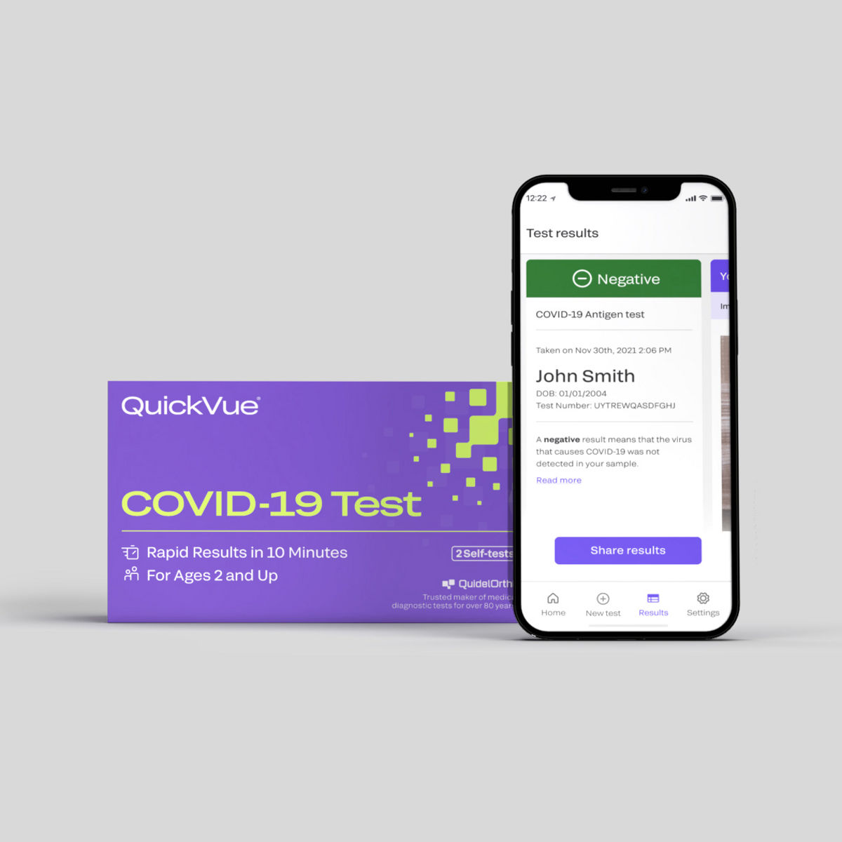 COVID-19 Test Kit package and smartphone with QVue app displayed/