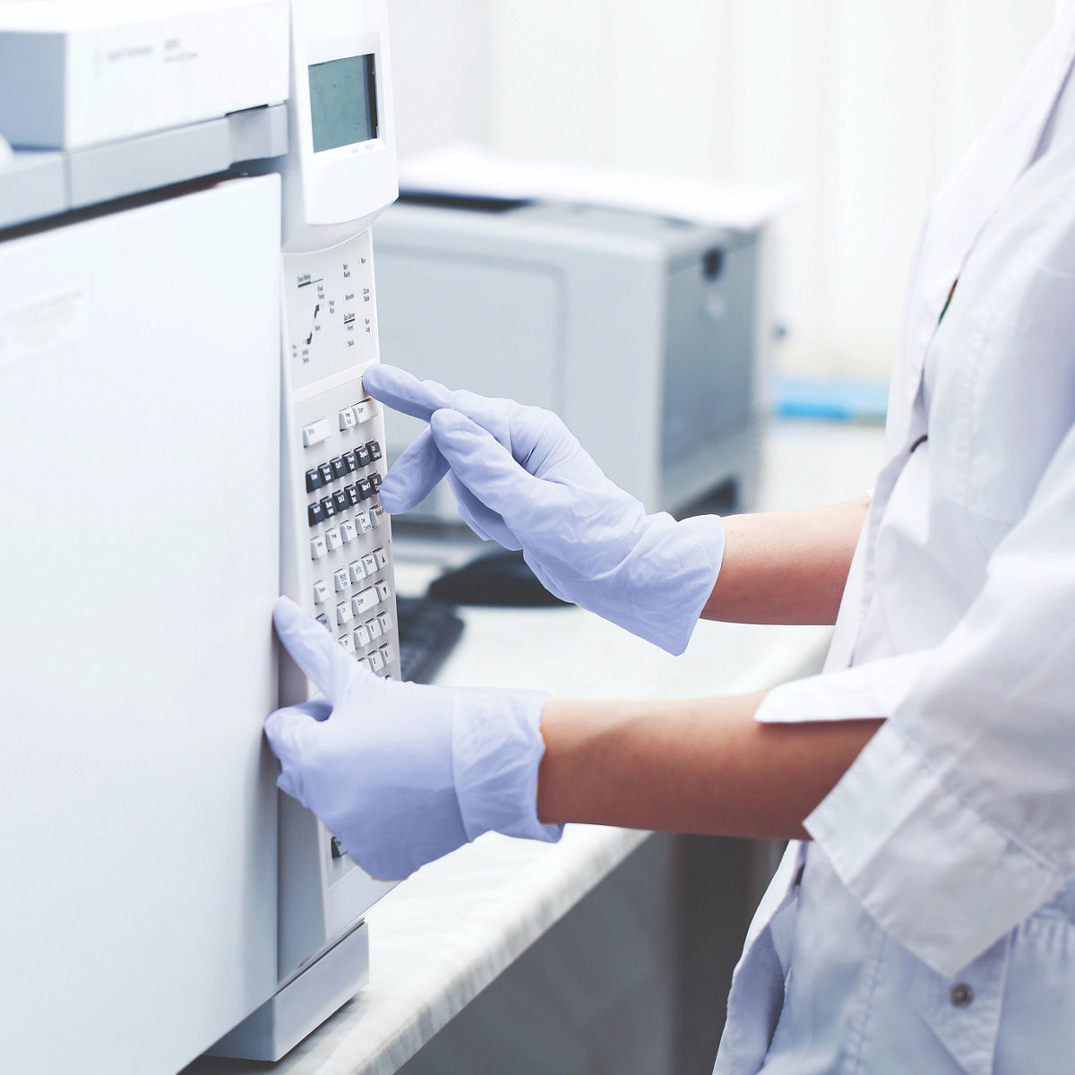 Lab technician working with large equipment./