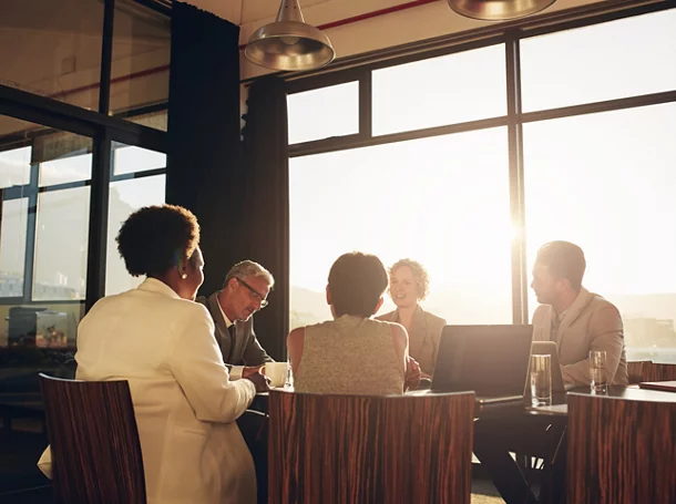 Diverse businesspeople having a late afternoon boardroom meeting