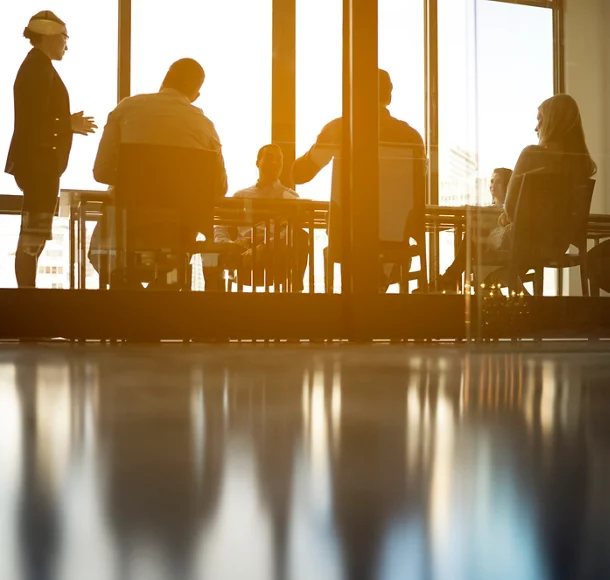 Colleagues discussing in board room