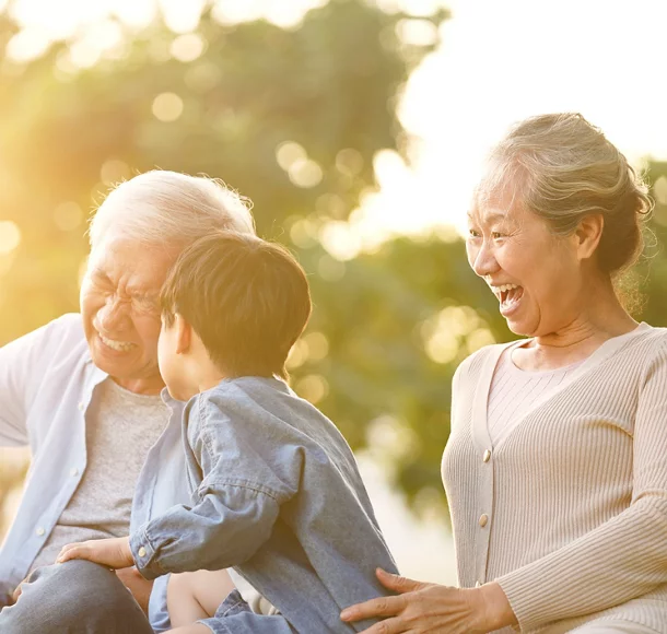 Asian grandparents having fun with grandson