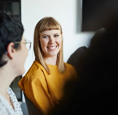 Entrepreneur looking at coworker in office meeting