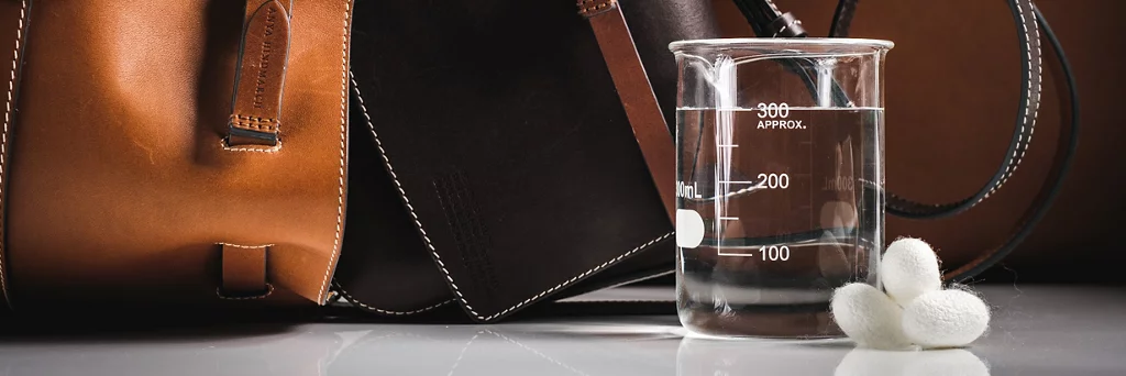 Brown handbag and glass beaker