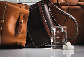 Brown handbag and glass beaker