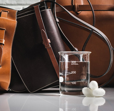 Brown handbag and glass beaker
