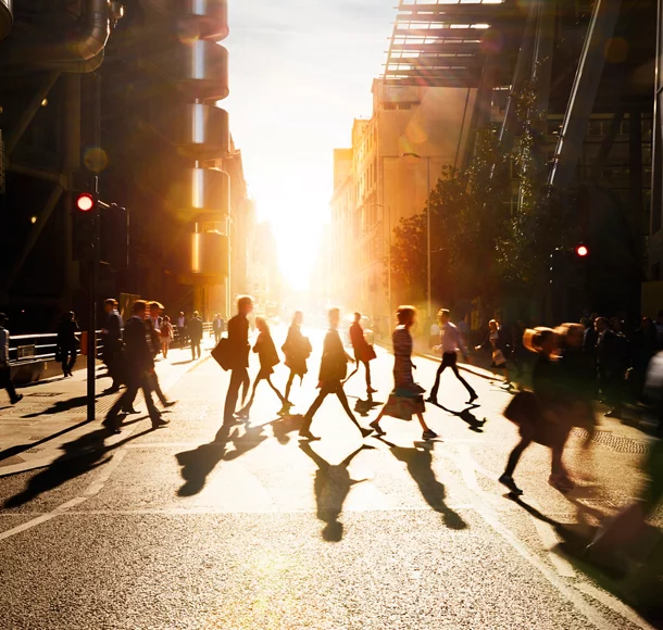 Employees walking to work in the city at sunrise