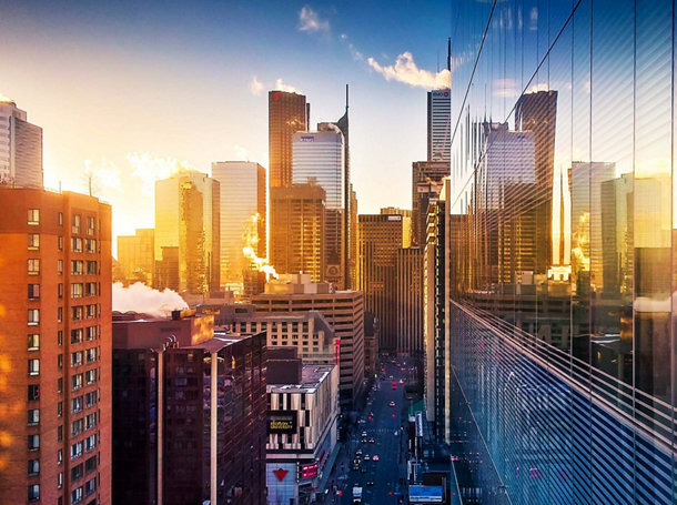 Sun rising over Toronto buildings