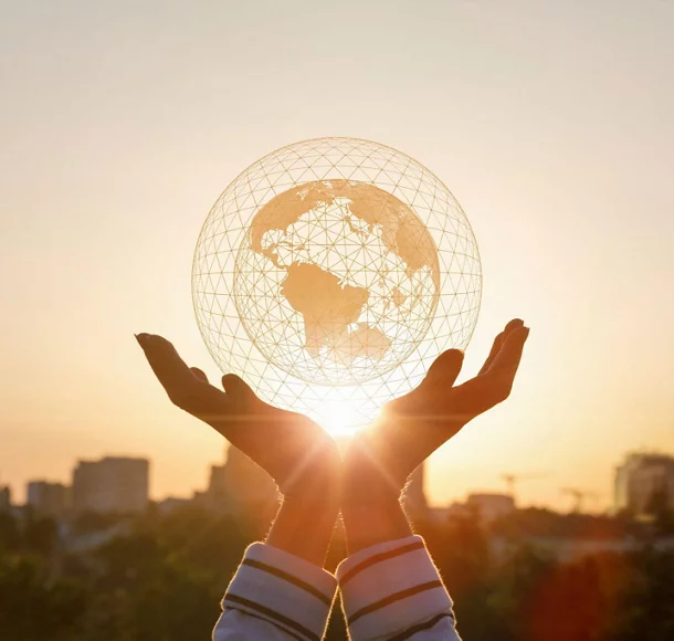 Hands holding a model of global network with a city background