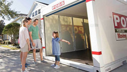 Family standing in front of a PODS storage container