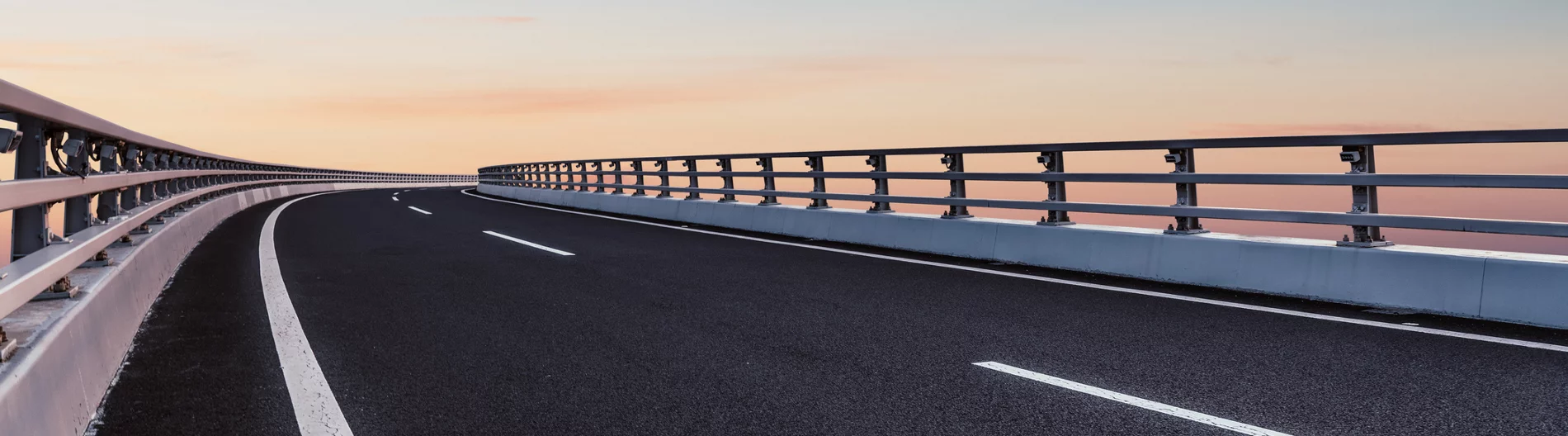 Empty road curves and disappears into the horizon.