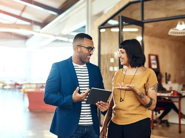Two colleagues talking in an office.