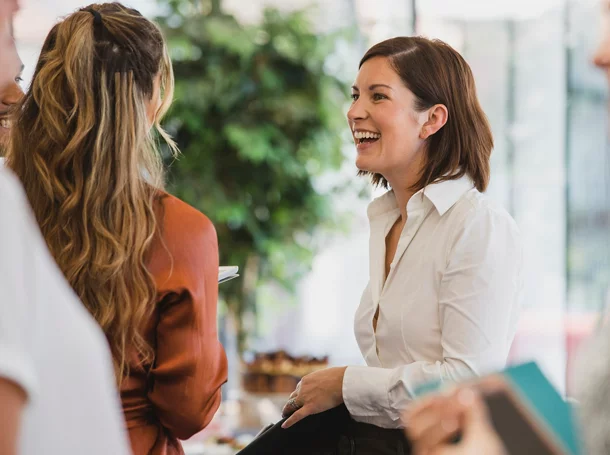 Cheerful colleagues laughing at a corporate event