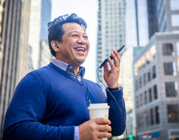 A man laughing talking on a mobile phone