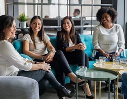 Women colleagues discussing and laughing