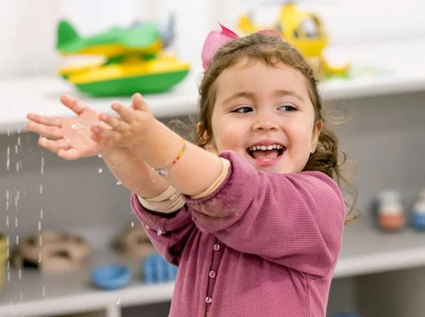 smiling girl playing with water