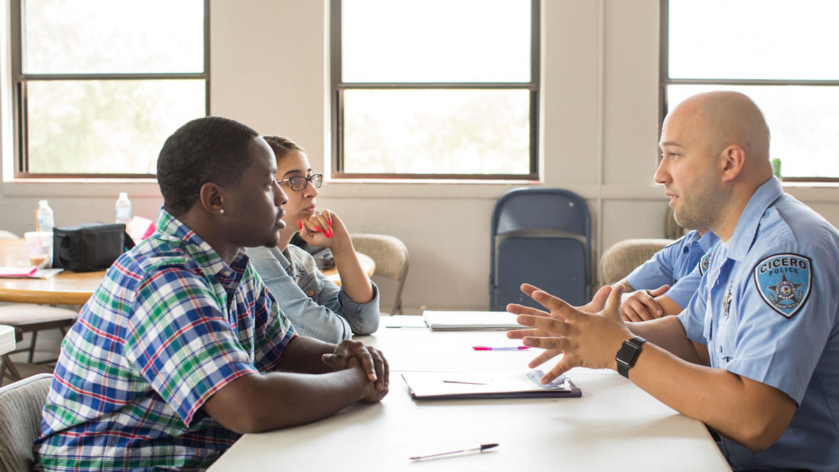 Branislav Dragisec (Caucasian officer) and Andrew Acervez (Hispanic officer)  leading a trama traning class for master and bachelor level interns. Deondre Nory (male student) and Jethabel Urbina (female student). Youth Crossroads is a non-profit community-based organization whose mission is to act in the best interest of youth, guiding them through life’s challenges, and inspiring them to discover new opportunities for personal development, healthy relationships, and positive community involvement.Since 1974, Youth Crossroads has assisted tens of thousands of youth and their families from the Berwyn, Cicero, Stickney, Forest View, and Lyons, Illinois communities. They collaborate extensively with local school districts, government agencies, police departments, and other human service organizations to provide youth and family counseling services, crisis intervention for runaway and locked-out youth, school/community-based trauma response and prevention programs, after-school enrichment programs, and youth leadership development services. All YC services are provided at no cost to youth and families and are bi-cultural, bi-lingual English/Spanish.