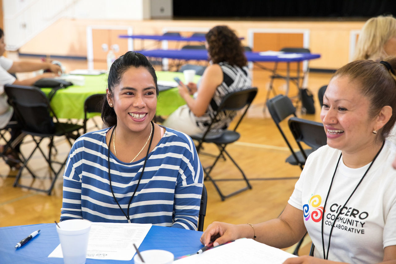 Lucia Hernandez (left) and Araceli Diaz (right) are Parent Ambassadors and are attending the Cicero Community Collaborative Meeting. The CCC works to enhance the quality of life for Cicero children, youth and families by working together to improve educational outcomes, parent engagement, health, and safety.They have a bold goal to have 10,000 Cicero children and youth  achieve their academic and developmental milestones by 2027.The Cicero Community Collaborative (CCC) is a coalition of local service providers who are developing a new initiative that will have long-term implications for the improved health, education, and well-being of Cicero children, youth and families.