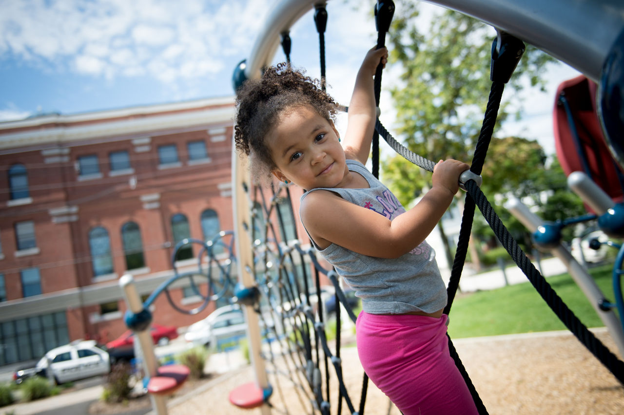 Phoenix Bruce, 3, plays on the new playground during the Ninth Annual Cookout and Block Party in Harriman Park in Manchester, N.H. on Thursday, Aug. 18, 2016. The cookout is a chance to bring community members together, but was special this year because of the new playground installed at the park.