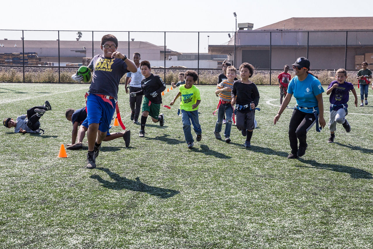Children playing flag football at Rumrill Sports Center at the new Rumrill Sports Park in an industrial part of San Pablo,where there are three new fields with artificial turf and field lights. San Pablo has the highest childhood obesity rate in the county — but the least amount of park and open space. The city and San Pablo Economic Development Corp. worked with federal and state agencies to rehabilitate vacant railroad land, then raised funds through the federal New Market Tax Credit program to build state-of-the-art fields. “We did not have a safe, lit, lined, turfed field anywhere around here. The nearest one is in Berkeley,” says Leslay Choy, general manager of the San Pablo Economic Development Corp.