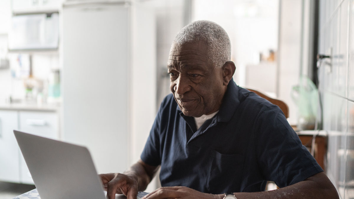 Senior man working at laptop