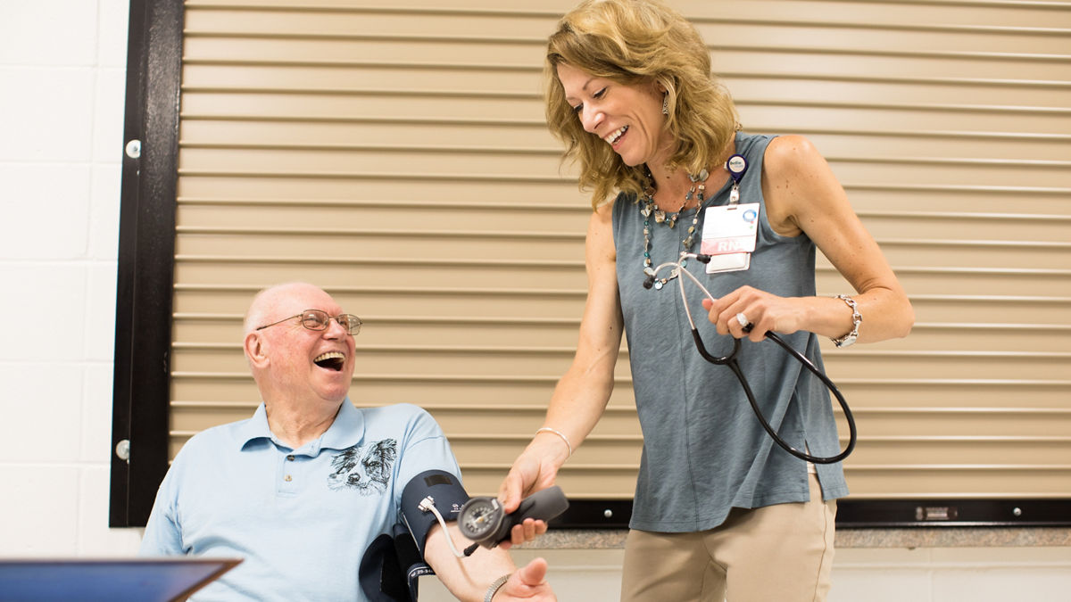 Algoma, WI COH 2017. The Wellness Center has a nurse on hand at all times with no charge. Nutrition, well being and general health advice is discussed and encouraged. Jody Anderson (right) is a nurse that connects with people to make Health and Exercise programs at the center. Elmer Willems (left) is seen getting his blood presure taken.