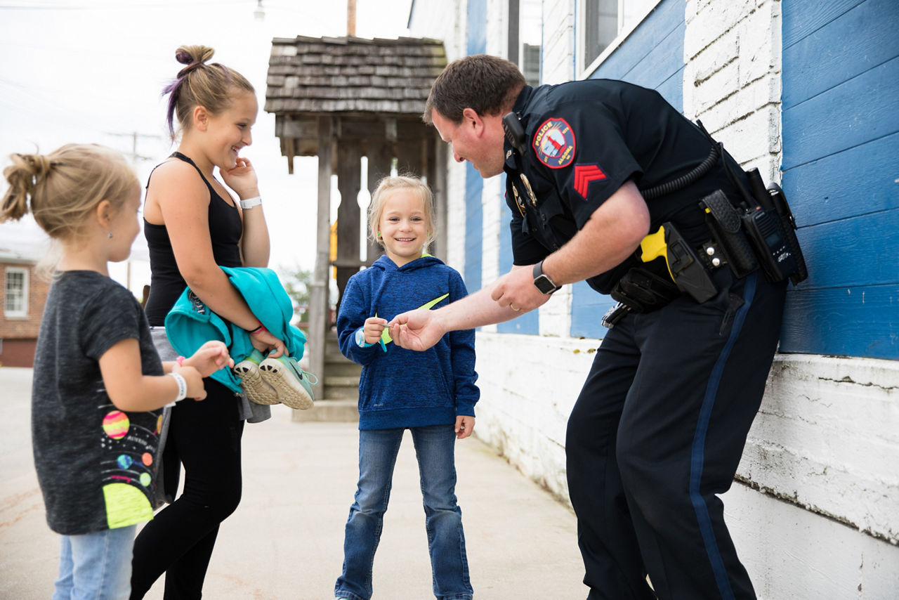 Algoma, WI COH 2017.  Shanty Days is a "celebration of the lake" as well as overall community pride. It's a three day, family festival that takes place on the Lake Michigan shore.  A parade, food, music, and 5K race are just some of the happenings. Officer Ryan Roesch hands out stickers to Berkley VanLanen (right) Lawsyn VanLanen (left) and Lyvia VanLanen (center sister).