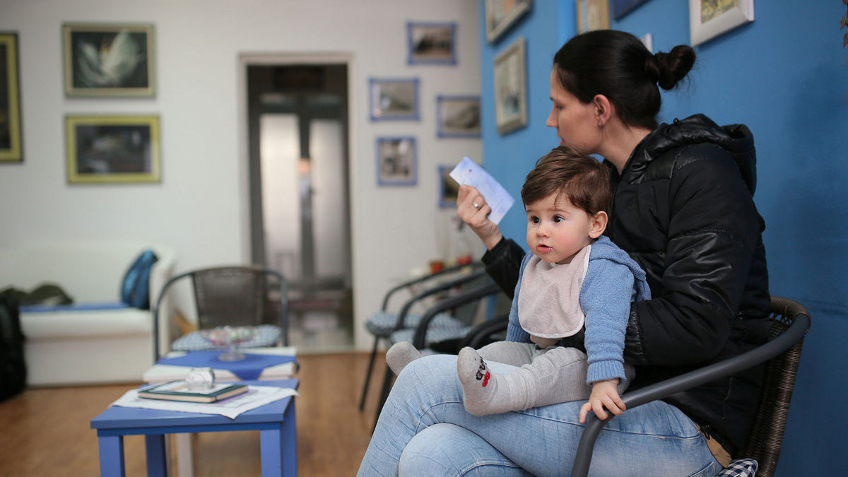 Young woman and her son at the doctor