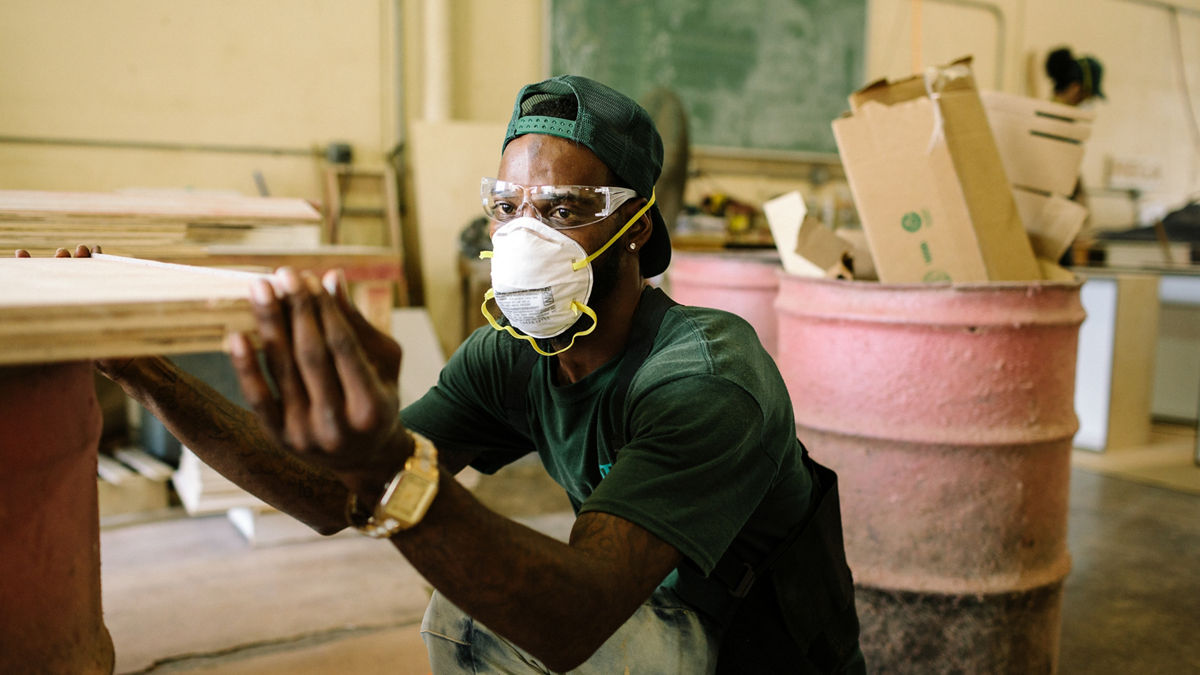Fort Lauderdale, FL - August 22, 2019 - Chadrick Lindsay (31), an apprentice in the City of Fort Lauderdale Housing Authority's Step Up program, prepares lumber to build cabinetry in the workshop.  The Housing Authority of the City of Fort Lauderdale has operated a state certified Step-Up Apprenticeship Program (Step-Up) since 1994. The objective of the program is to provide apprentices with the opportunity to create a portfolio of education, training, and employment skills to increase their potential for permanent employment and economic self-sufficiency. During the two-year state certified program, apprentices are trained in construction skills with a specialty in housing rehabilitation and building maintenance for occupations in the public and private sectors. All apprentices are required to obtain their GED while in the program and certified instructors teach morning and evening classes at the Housing Authority to help prepare the apprentices for the exam.