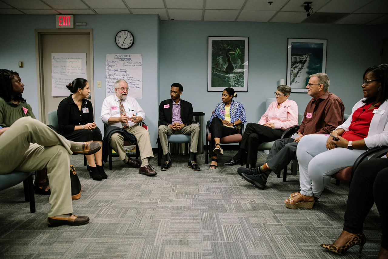 Broward County, FL - August 23, 2019 - Suzanne Bundy, Senior Project Program Coordinator at Dismantling Racism Initiative of Broward County (second from left) leads a debrief meeting for community members who recently went through race and racism training.