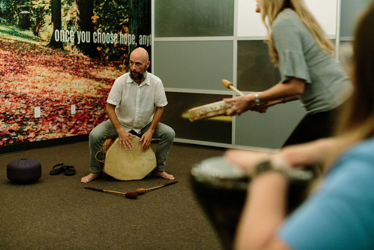 Parkland, FL - August 23, 2019 - Jaret Brook leads a drumming circle at  Eagles' Haven.Next door to a health food store in a strip shopping center, a new drop-in wellness center presents an immediate aura of calm. A circle of teens practices deep breathing exercises. Other young people meet with staff in private rooms, decorated with murals of mountains and motivational sayings like, The best views come after the hardest climbs. This is Eagle’s Haven, and it is just across the highway in the Parkland neighborhood from Marjory Stoneman Douglas High School (MSD), where a lone shooter killed 17 and injured 17 on Feb. 14, 2018.“I wondered, ‘How am I ever going to teach again?’ ” says Diane Wolk-Rogers, a history teacher at MSD. After going through training, she shared what she learned with students, staff and parents. The idea spread, and about 100 students now serve as Mind Body Ambassadors and teach calming techniques to others. The initiative has been so effective that CSC wants to introduce clubs across the school district.
